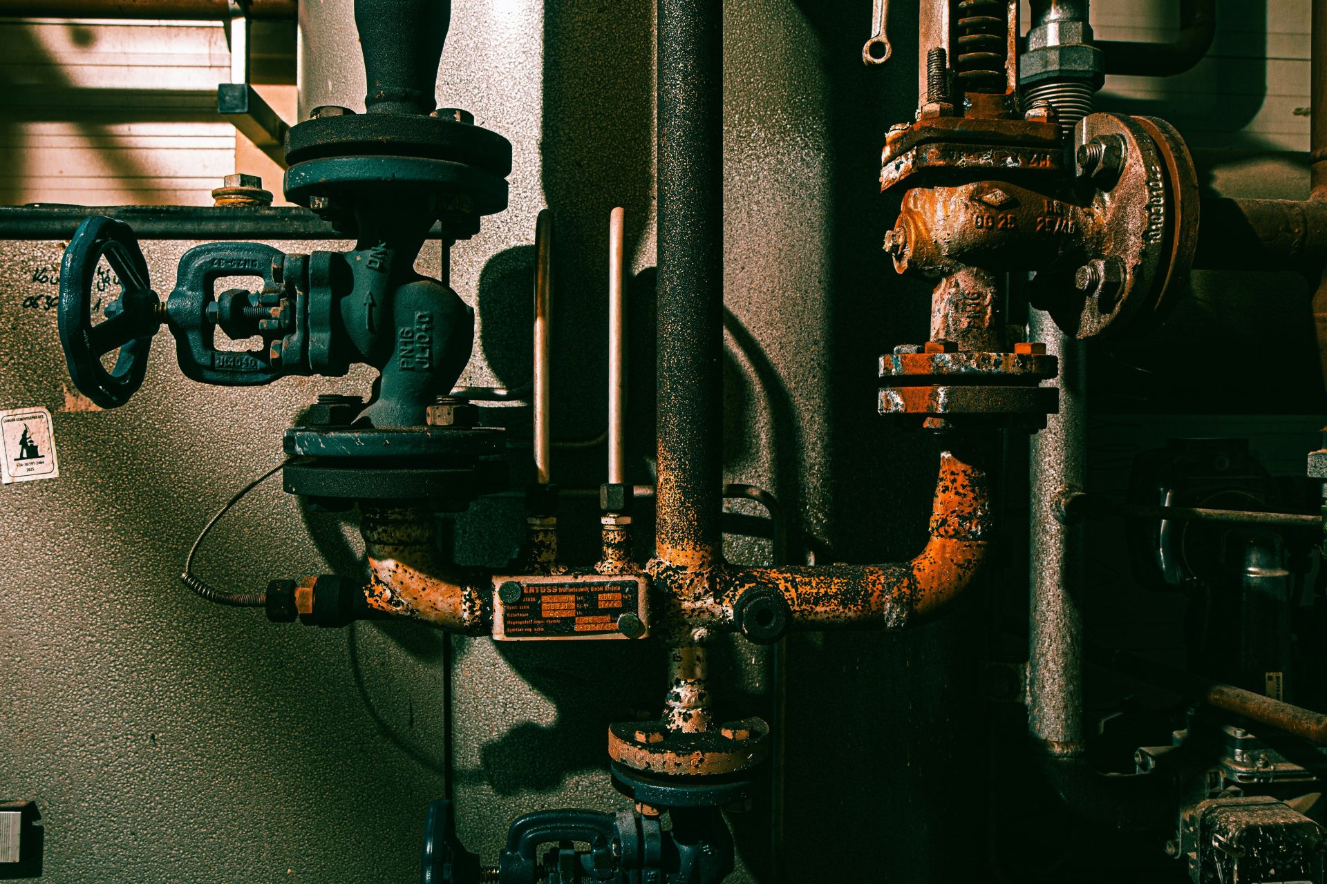 Rusty industrial pipes and valves in a factory